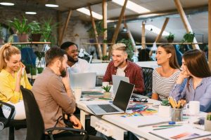 creative-start-up-team-discussing-ideas-in-modern-office-e1640485247215.jpg