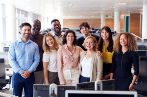 portrait-of-smiling-business-team-working-in-modern-office-together-e1640485294113.jpg